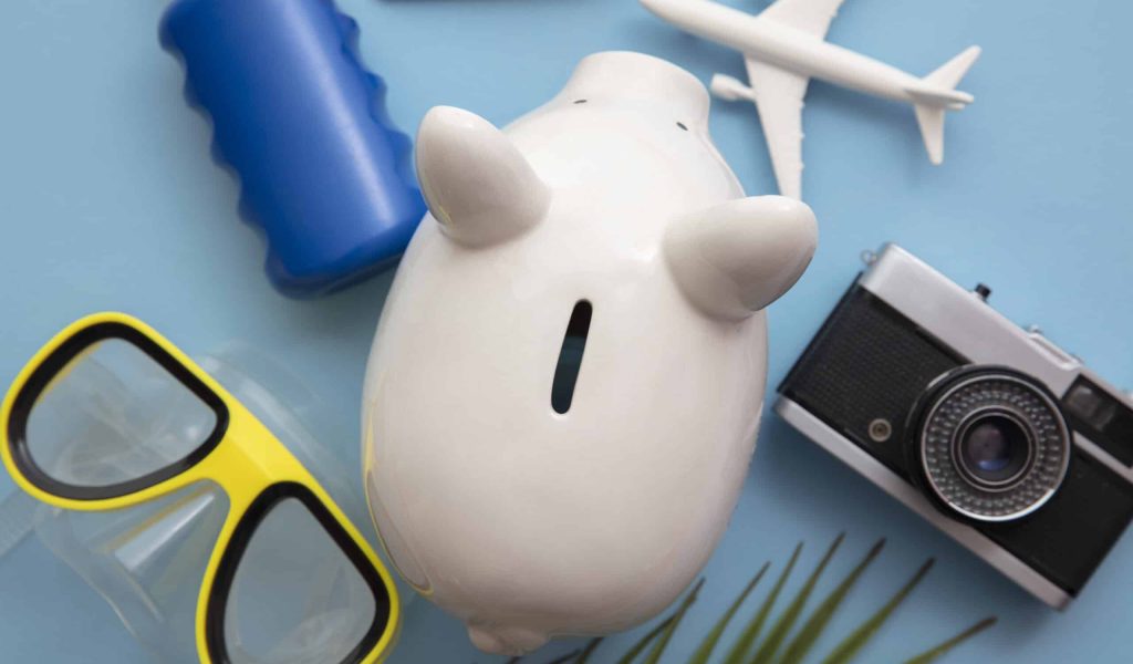 Summer holiday piggy bank background. Saving up for a vacation.